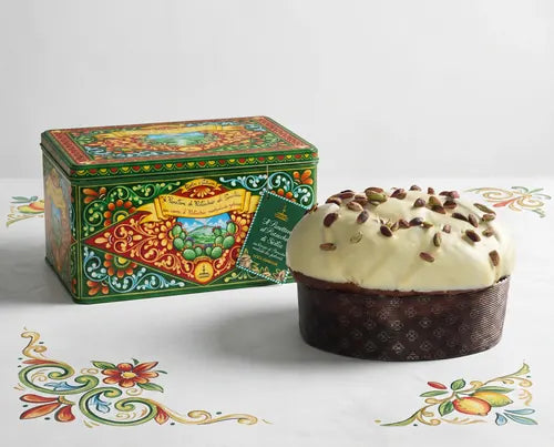 Panettone de pistacho Fiasconaro Dolce & Gabbana junto a su lata ilustrada